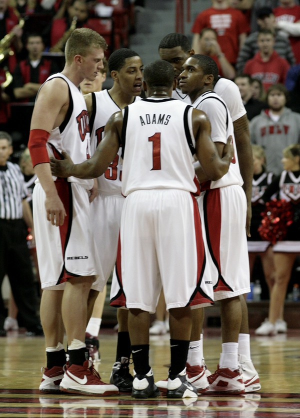 Players meet during a break in the action Wednesday night ...