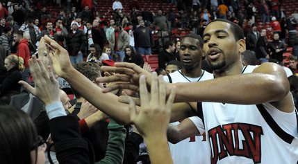 Rene Rougeau and Darris Santee give fives to the Rebels fans Wednesday night as UNLV takes on Santa Clara. UNLV won 78-66.
