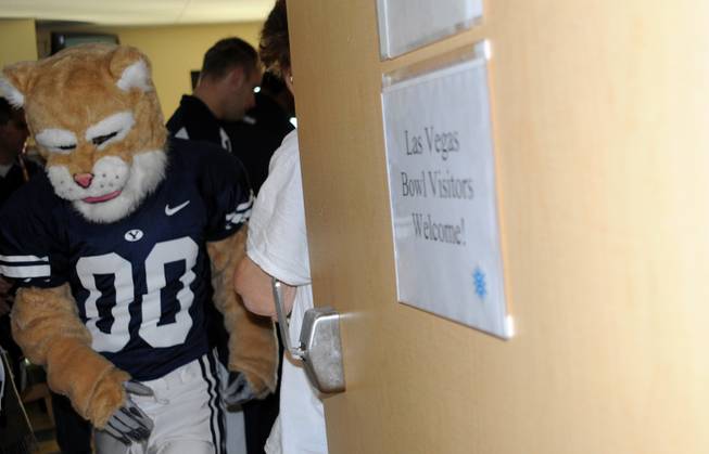 Members of the BYU and Arizona football teams visit Sunrise Children's Hospital to deliver gifts to long-term patients.  