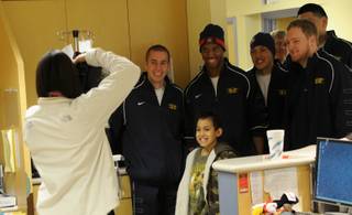 Members of the BYU and Arizona football teams visit Sunrise Children's Hospital to deliver gifts to long-term patients.  