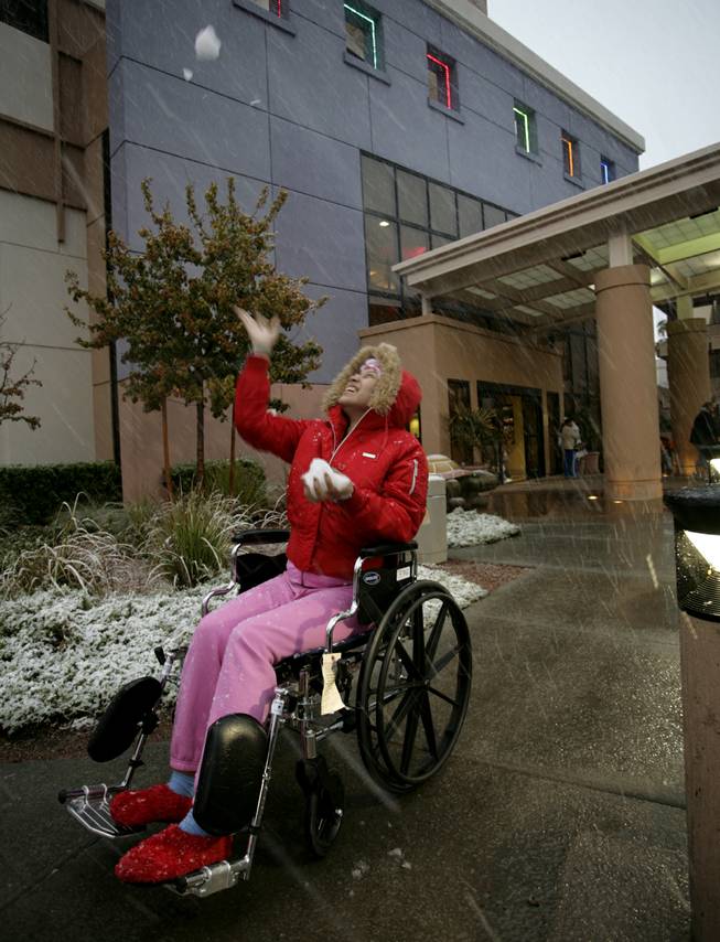 Mayra Altamirano age 17, a cancer survivor from Las Vegas gets to get out of the walls of Sunrise Hospital and outside to enjoy the falling snow Wednesday evening.  