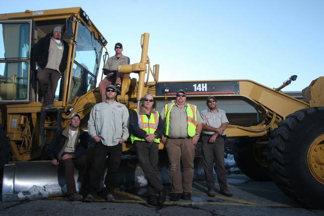 Ed Owens, left on grader, cleared the way to Anthem. Also on the machine is Clint Hall. At bottom, from left, are fellow city workers Darwin Barton, Ryan Minehan, Kurt "Sgt. Sweeper" Eckhardt, Don Nash and Ron Reed.