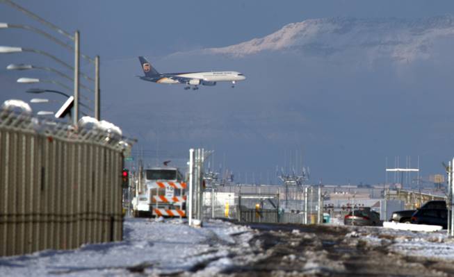 A United Parcel Service jet lands at McCarran International Airport Thursday. A rare snowstorm blanketed the Las Vegas Valley on Wednesday, delaying flights, causing widespread fender-benders and canceling school. More than 6 inches of snow fell in parts of the valley, forecasters said.