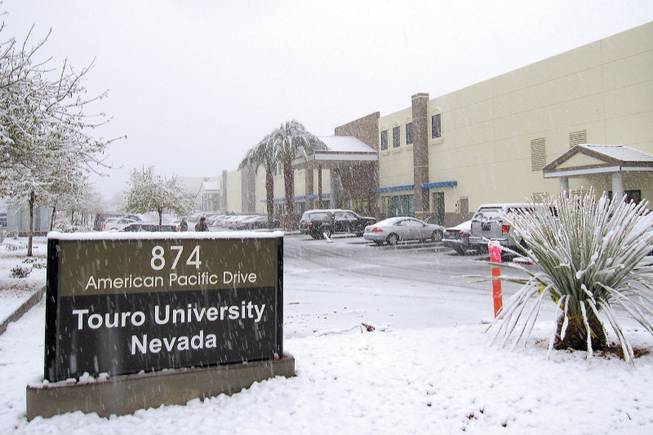 A blanket of snow covers the parking lot outside Touro University Nevada in Henderson on Wednesday.