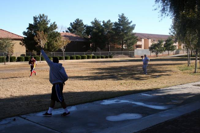 Three boys celebrate the day off from school at Winchester Park and a game of backyard football Thursday.