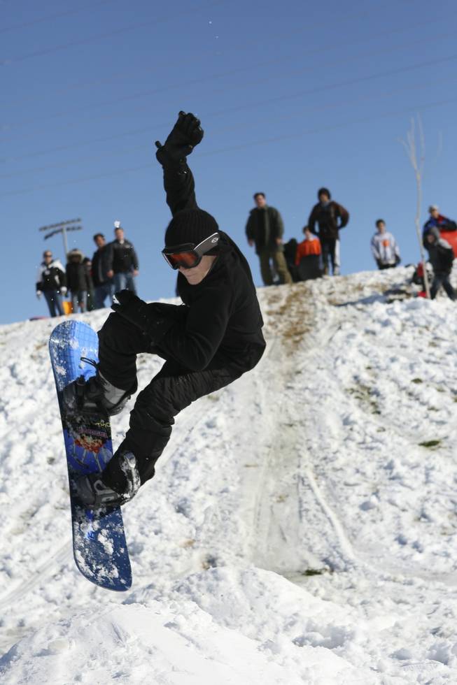 Enjoying his day off school, Brian Battaglia, 13, catches some air snowboarding at Anthem Hills Park Thursday morning.