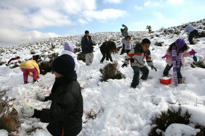 Kids play in the snow at Red Springs in Red Rock Canyon National Conservation Area Thursday.