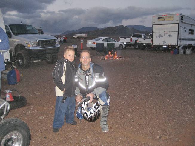 Andrew Kovacevich and his father, Greg Kovacevich, pause at an off-road racing site. Kovacevich recently wrapped up his second year of competition in the Best in the Desert off-road racing series.