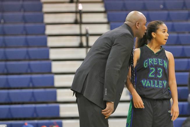 Green Valley High girls basketball coach Lorenzo Jarvis whispers directions to his daughter, Gator guard Jazmine Jarvis, during a timeout of the Gators' 75-43 loss at Bishop Gorman Dec. 11.