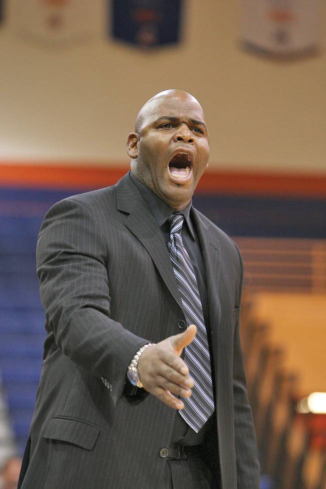 Green Valley High girls basketball coach Lorenzo Jarvis reacts to a referee's call during the second quarter at the Gators' 75-43 loss to Bishop Gorman.