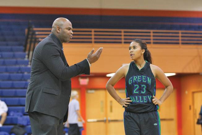 Green Valley High girls basketball coach Lorenzo Jarvis talks strategy with his daughter, Gator guard Jazmine Jarvis, during the third quarter of Green Valley's 75-43 loss to Bishop Gorman Dec. 11.