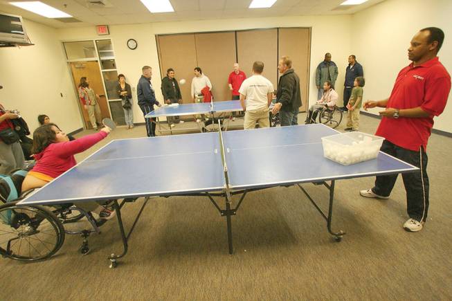 Karla Aceves, 10, left, plays ping pong with Ken Houston, an adaptive P.E. teacher with Clark County School District, during the year's final Paralympic Academy event Dec. 10 at the Henderson Multigenerational Center.