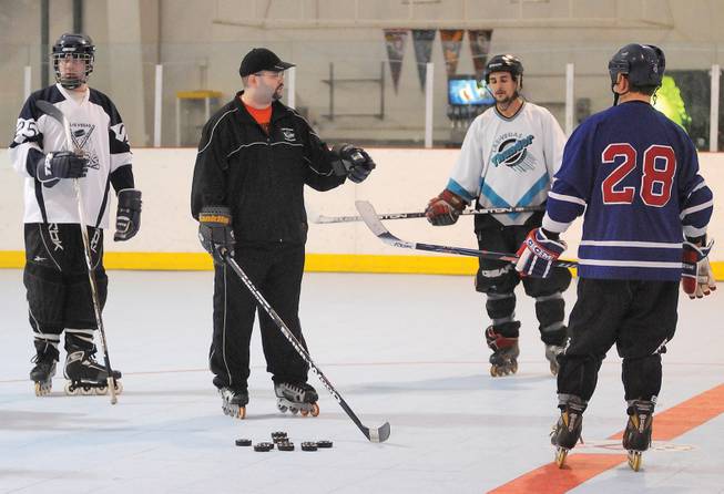 Las Vegas Aces head coach Adam Stio, center, instructs his players during a team practice at the Las Vegas Roller Hockey Center on Dec. 14.