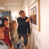 From right, Photographer Gary Reese, owner of the Plaza Gallery, 223 S. Water Street, describes a photograph from his exhibit "State of Change" to Valan Mallory, 5, Aliysa Mallory, 11, and Sausha Goaves, 8, during the Third Thursday Arts Walk.