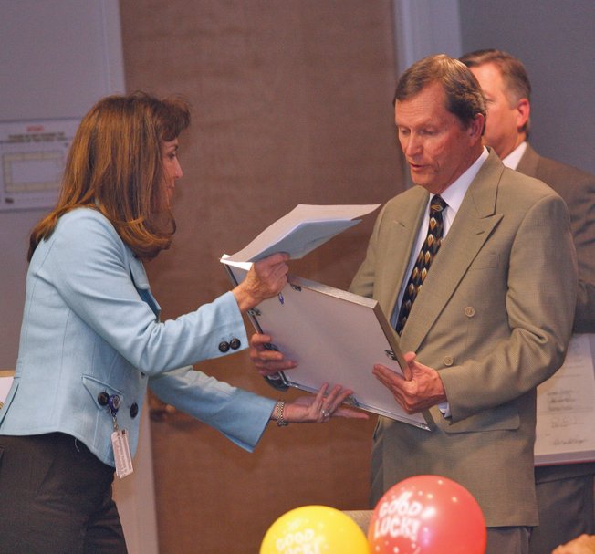 Clark County Manager Virginia Valentine, left, presents Clark County Commissioner Bruce L. Woodbury with a plaque acknowledging his decades of service on the commission during a farewell celebration at the Clark County Government Center on Dec. 17. His current term of office expires the first Monday in January 2009.