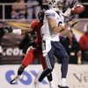Austin Collie of BYU catches a pass while Devin Ross of Arizona defends during the Pioneer Las Vegas Bowl at Sam Boyd Stadium on Saturday.