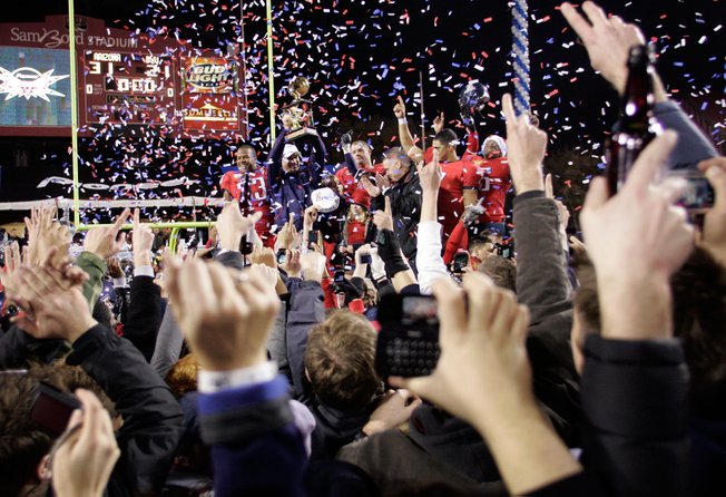 Arizona celebrates a win over BYU in the Pioneer Las Vegas Bowl at Sam Boyd Stadium on Saturday. Arizona won the game 31-21.