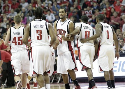 The Rebels run to their bench during a timeout Saturday during their matchup against Arizona. The Rebels defeated the Wildcats 79-64.