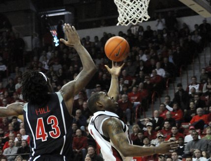 Wink Adams lays it up and over Arizona's Jordan Hill on Saturday at the Thomas & Mack Center. 