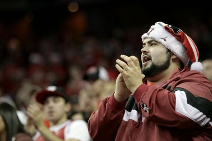 A Rebels fan cheers during a break in the action Saturday. The Rebels defeated the Wildcats 79-64.