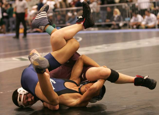 Bronson Ashjain of Cimarron-Memorial, left, and Jordan Feguis of Deer Valley High School in Arizona wrestle in the 105 lbs. meet during the Las Vegas Holiday Classic Wrestling Tournament at the Las Vegas Convention Center Dec. 19.
