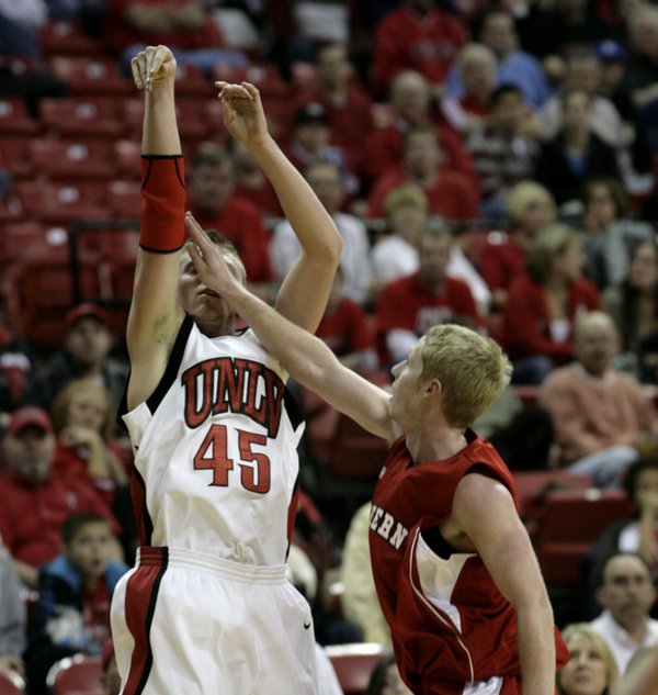 Joe Darger hits a three with a hand in the ...