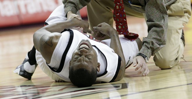Wink Adams struggles to get up after falling to the floor in pain with an abdominal injury Dec. 23 at the Thomas & Mack Center. 