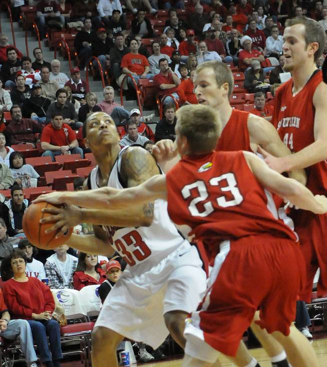 Tre'von Willis goes up against three defenders Tuesday at the Thomas & Mack, where UNLV took on Southern Utah. 