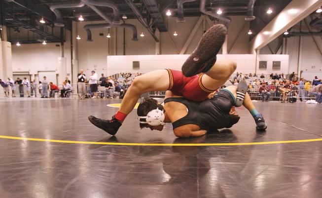 Mason Saldana of Green Valley, bottom, and Daniel Flores of El Modena High School in California wrestle in a 121 lbs. match during the Las Vegas Holiday Classic Wrestling Tournament at the Las Vegas Convention Center on Dec. 19.
