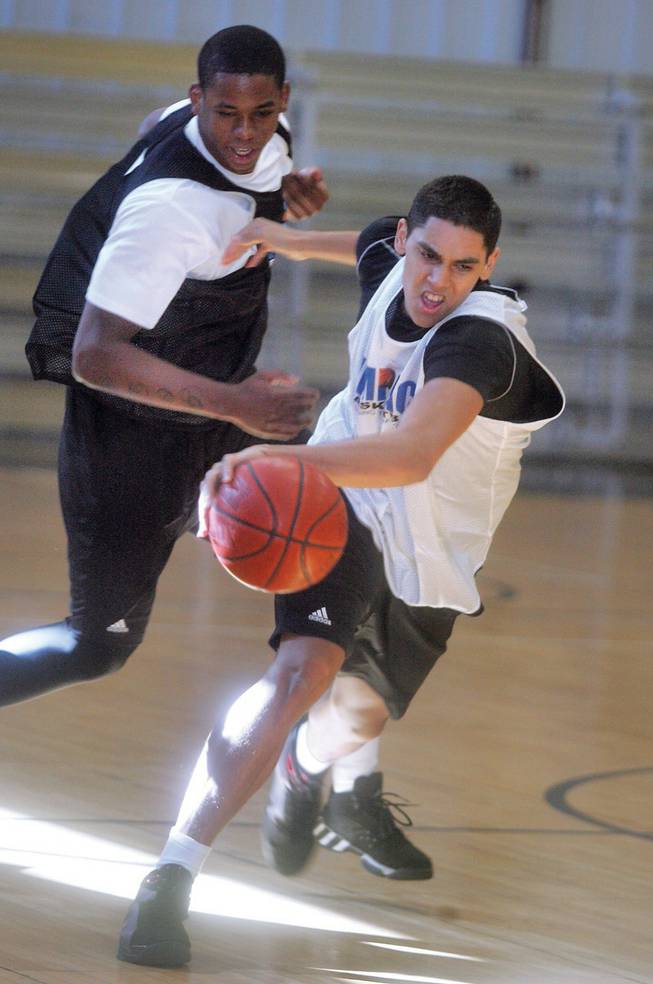 From left to right, Jordan Hill covers Marcus Harvey during the Impact Basketball program's prep basketball team practice at Tarkanian Basketball Academ.
