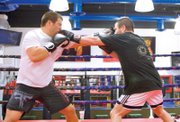 MMA fighters Danny (left) and Marco Scoalri box during their training session at the Las Vegas Athletic Club.