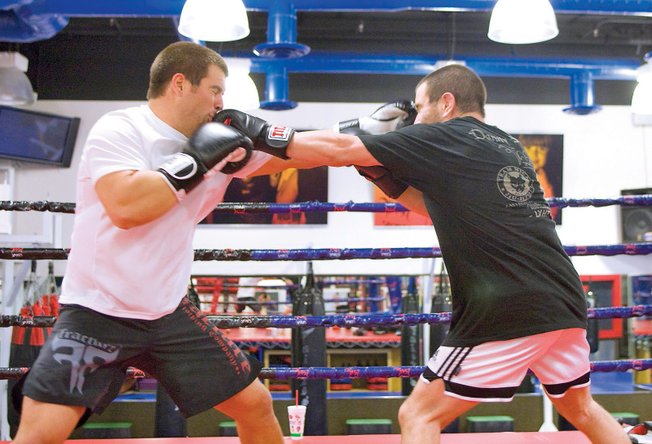 MMA fighters Danny (left) and Marco Scoalri box during their training session at the Las Vegas Athletic Club.