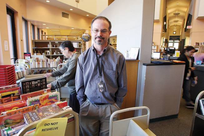 Andrew Kaplan, a children's librarian at the Green Valley Library, will move with the books and equipment to the new Centennial Hills Library, 25 miles to the north.