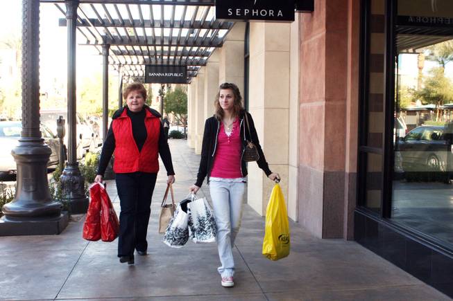 Wyoming residents Gloria Wade, left, and Jamie Earnett take advantage of after Christmas bargains through out Town Square on December 26, 2008.

