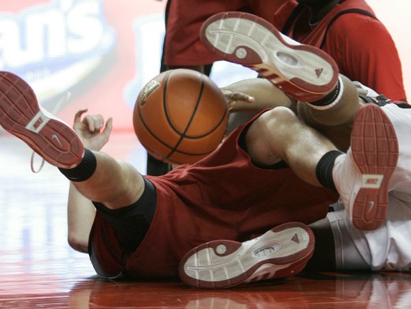 The ball is surrounded by the feet of UNLV player ...