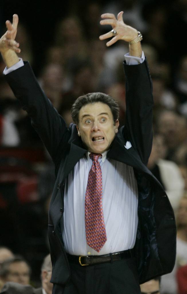 Louisville coach Rick Pitino directs his team during the first half in Louisville, Ky.