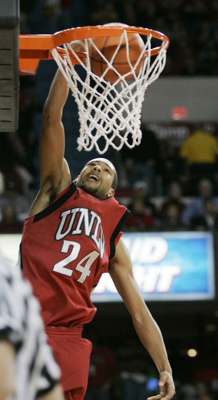 UNLV's Rene Rougeau slams a dunk through the basket during the first half against Louisville.