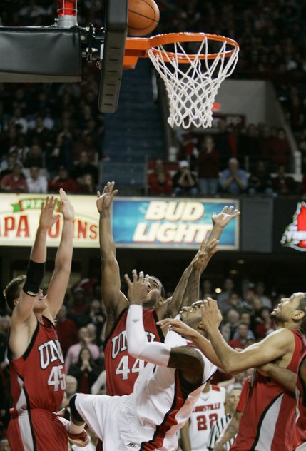 Louisville's Terrence Williams, center, and UNLV players, from left, Joe Darger, Darris Santee and Rene Rougeau, watch Williams' shot bounce off the rim with time running out to give UNLV a 56-55 win.