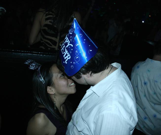 11:50 p.m.: A couple practices for the imminent New Year's kiss just moments before the countdown begins at Rain.
