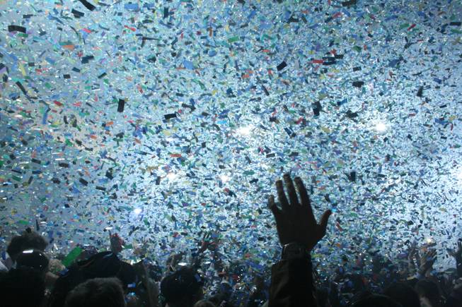Midnight: Rain rings in 2009 with a cloud of colorful confetti and the sounds of Perfecto DJ Paul Oakenfold.