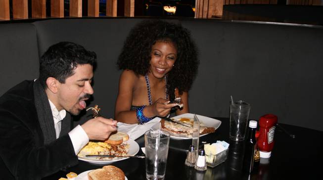 <p>4:30 a.m.: Will Rodriguez, left, and Christina Rowe, right, met on the Palms casino floor and got to know each other over an early New Year's Eve breakfast at the casino's 24/7 Cafe.</p>

<p>"My friends went to bed and want to sleep in," Rowe explained.</p>

<p>The pair met while playing the slots but later took their chances on roulette before cashing in for the night.</p>

<p>"I saw her at the slot machines and I told her, 'I'm going to play roulette'," Rodriguez said.</p>

<p>"I said bet fours and fives," Rowe said. "He didn't listen to me -- but he should have."</p>

<p>"I bet on sevens, I think, and I lost," Rodriguez said.</p>

<p>But all was not lost at the roulette tables, as Rodriguez won himself a casual breakfast date.</p>

<p>Rowe ordered the country fried steak and eggs while Rodriguez opted for the three egg breakfast, scrambled, with hashbrowns.</p>

<p>The new pair agreed said breakfast was just what the doctor ordered after a long night of partying at the Palms.</p>

<p>Rowe spent the night at Moon while Rodriguez rang in 2009 at Rain.</p>

<p>"It absorbs all the alcohol," Rowe said with a laugh. "And it's already late so it's close to the morning time."</p>

<p>As it tuned out, she and Rodriguez were lucky to enjoy their eggs when they did: When the rest of the hotel's guests awoke to the first morning of the year a few short hours later, crowds of hungry partiers converged upon the popular breakfast spot.</p>

<p>And while grumbling stomachs were forced to wait in line, Rowe and Rodriguez didn't have to worry since breakfast was already taken care of.</p>
