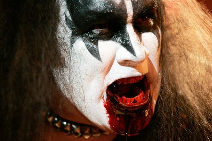 Jim Seda portrays Gene Simmons with fake blood coming out of his mouth in the band The Original Kiss Army during Tribute Palooza, the New Year's Eve party at the Fremont Street Experience in downtown Las Vegas Wednesday. 