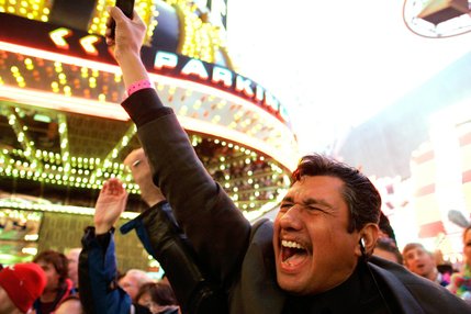 David Chavez of Las Vegas cheers for the new year after midnight during Tribute Palooza, the New Year's Eve party at the Fremont Street Experience in downtown Las Vegas Thursday.