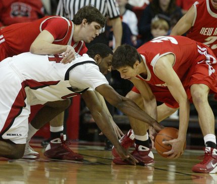 UNLV forward Darris Santee loses the ball to New Mexico forward Daniel Faris, left, and guard Tony Dandridge during the first half of their game at the Thomas & Mack Center Saturday. UNLV won the conference opener 60-58. 