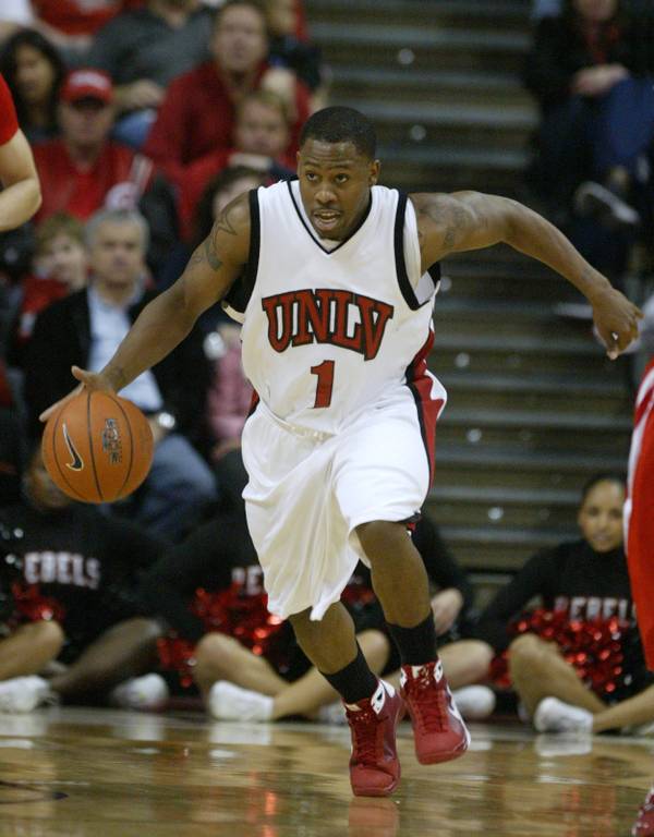 UNLV guard Wink Adams takes the ball up the court ...