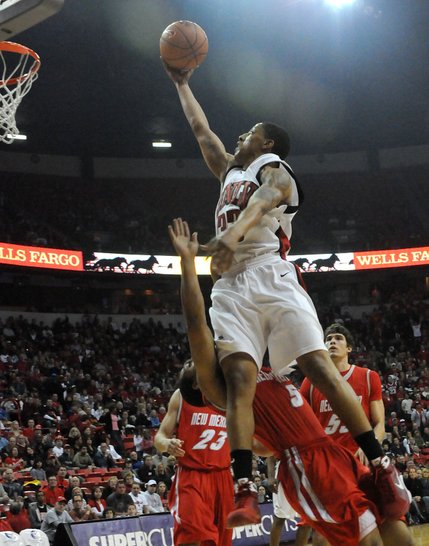 Tre'Von Willis lays it in over Dairese Gary on Saturday at the Thomas & Mack Center as UNLV took on New Mexico. 
