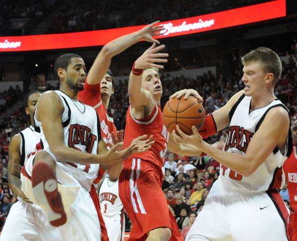 The Rebels and Lobos fight over a loose ball Jan. ...