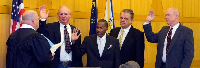 Chief Judge Art Ritchie, left, of 8th Judicial Court, swears in county commissioners (left to right) Tom Collins, Lawrence Weekly, Steve Sisolak and Larry Brown on Monday at the Government Center in Las Vegas.
