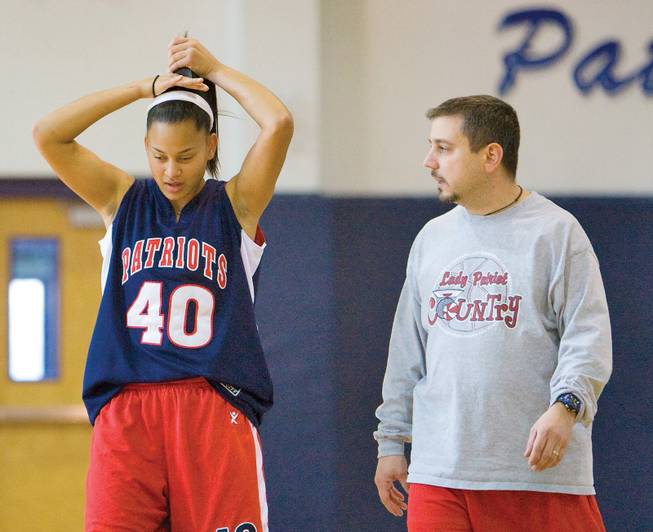 Liberty girls' basketball star Jade Washington talks with coach Chris Zunno during practice at Liberty High School.
