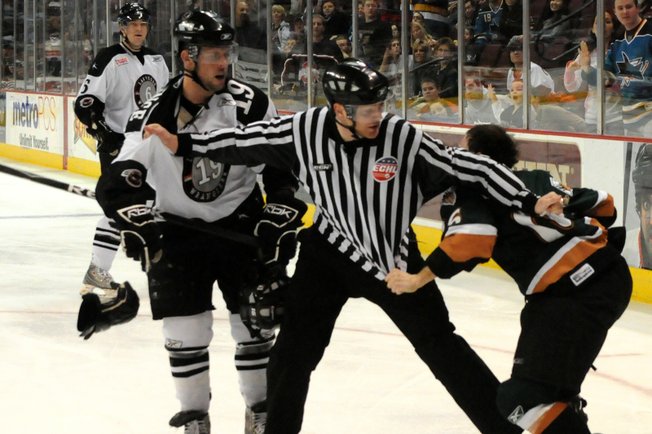 Las Vegas Wranglers forward Mick Lawrence (19) battles Utah forward Evan Kotsopoulos on Jan. 2.
